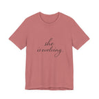 She Is Evolving Tee — Feminine Script Inspirational T-Shirt