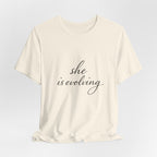 She Is Evolving Tee — Feminine Script Inspirational T-Shirt