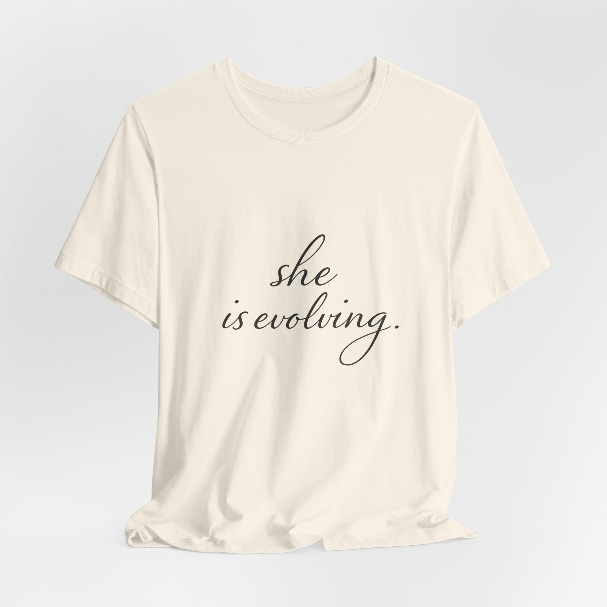 She Is Evolving Tee — Feminine Script Inspirational T-Shirt