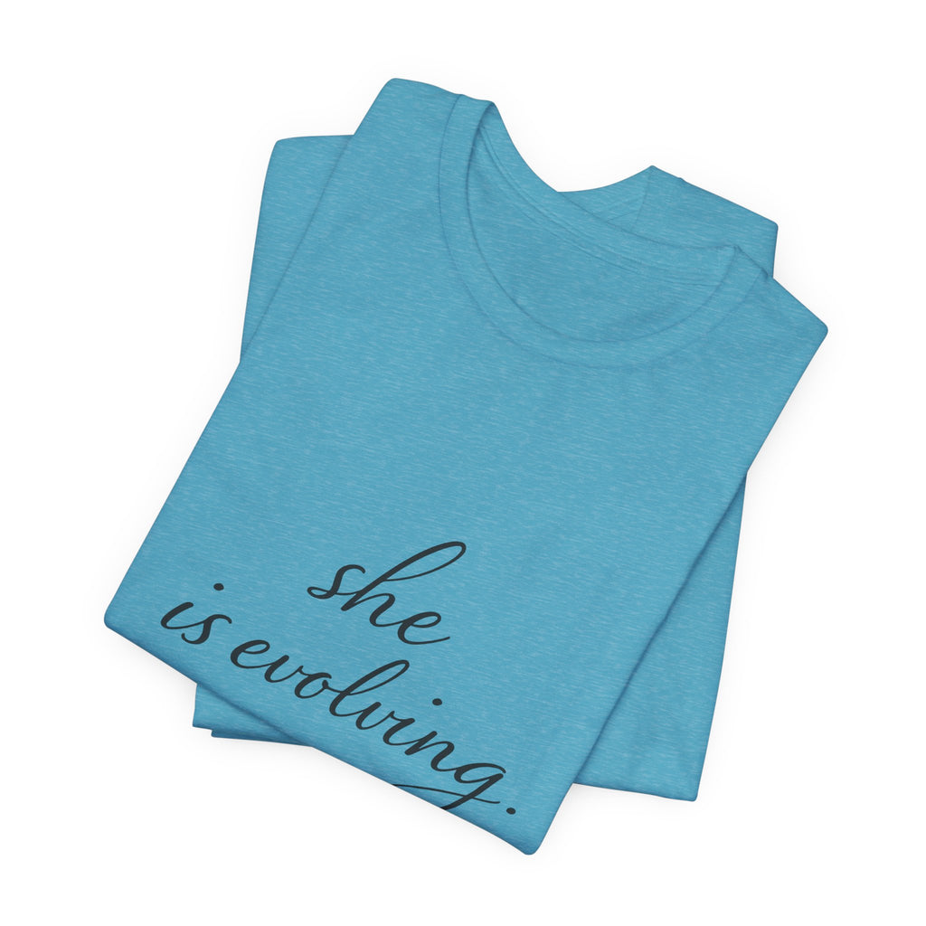 She Is Evolving Tee — Feminine Script Inspirational T-Shirt