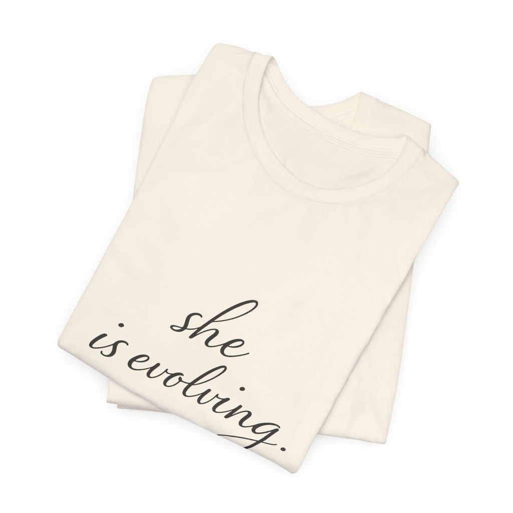 She Is Evolving Tee — Feminine Script Inspirational T-Shirt