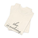 She Is Evolving Tee — Feminine Script Inspirational T-Shirt