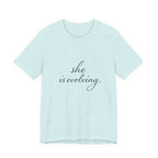 She Is Evolving Tee — Feminine Script Inspirational T-Shirt