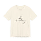 She Is Evolving Tee — Feminine Script Inspirational T-Shirt