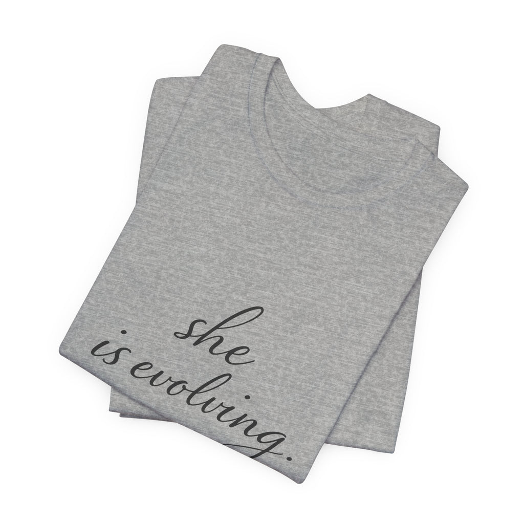 She Is Evolving Tee — Feminine Script Inspirational T-Shirt