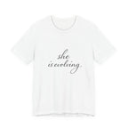 She Is Evolving Tee — Feminine Script Inspirational T-Shirt