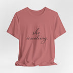She Is Evolving Tee — Feminine Script Inspirational T-Shirt
