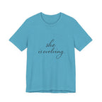 She Is Evolving Tee — Feminine Script Inspirational T-Shirt