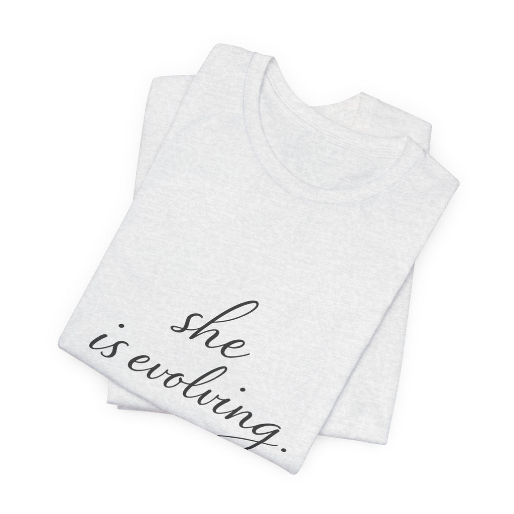 She Is Evolving Tee — Feminine Script Inspirational T-Shirt