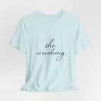 She Is Evolving Tee — Feminine Script Inspirational T-Shirt