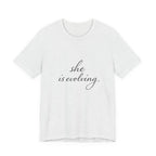 She Is Evolving Tee — Feminine Script Inspirational T-Shirt