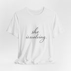 She Is Evolving Tee — Feminine Script Inspirational T-Shirt