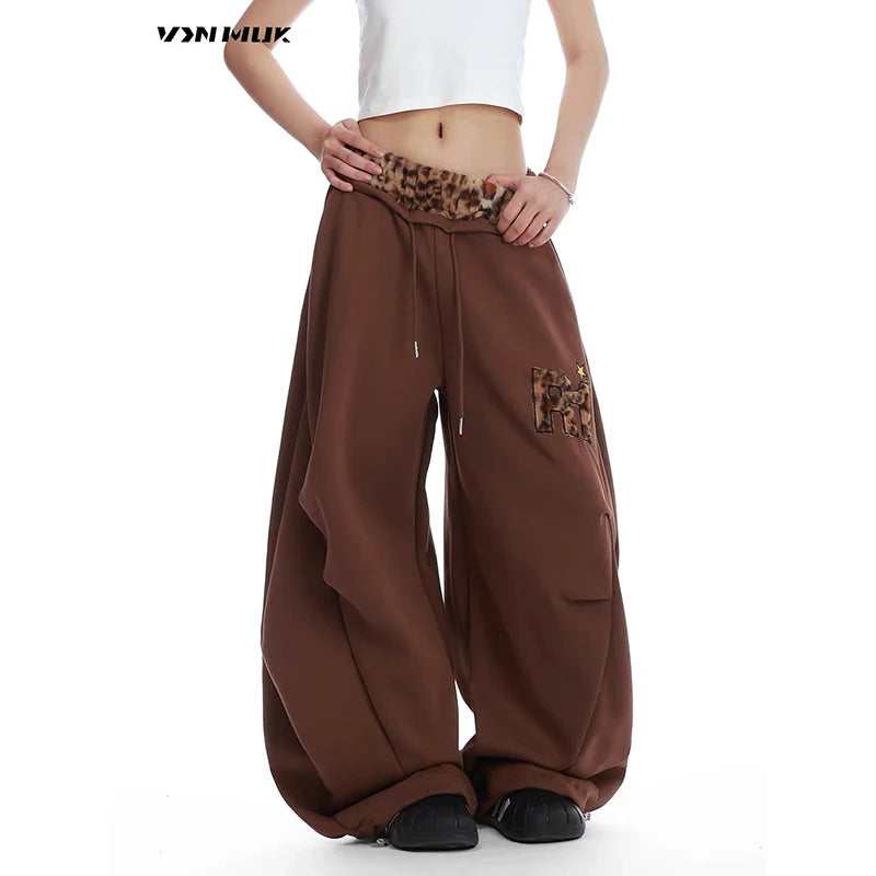 Brown baggy pants with leopard print details on a white background - Winstar Marketing
