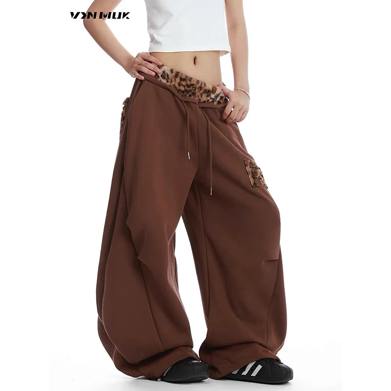 Brown baggy pants with leopard print details on a white background - Winstar Marketing
