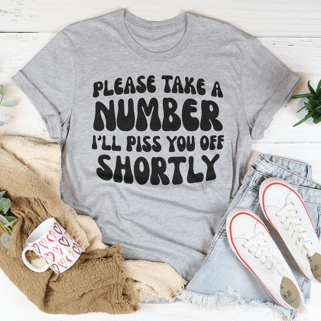 "Please Take A Number I'll Piss You Off Shortly" – Relatable Sarcasm Graphic Shirt