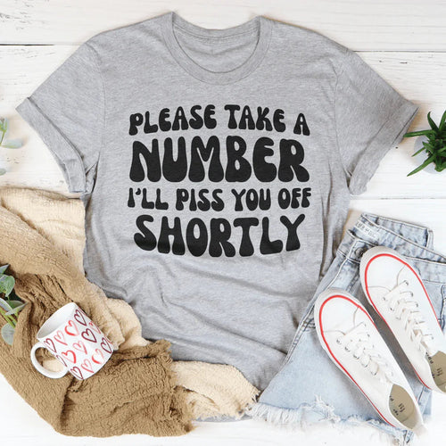 "Please Take A Number I'll Piss You Off Shortly" – Relatable Sarcasm Graphic Shirt